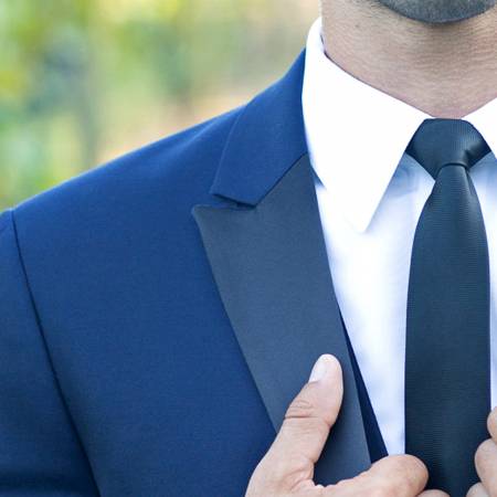 blue tuxedo with black satin lapel and black tie